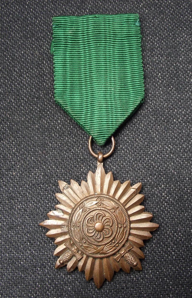 WW2 German Bronze Ost Volk Medal With Swords. MM/27.