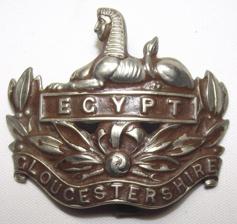 Gloucestershire Regiment Brown Painted  White Metal Cap Badge.